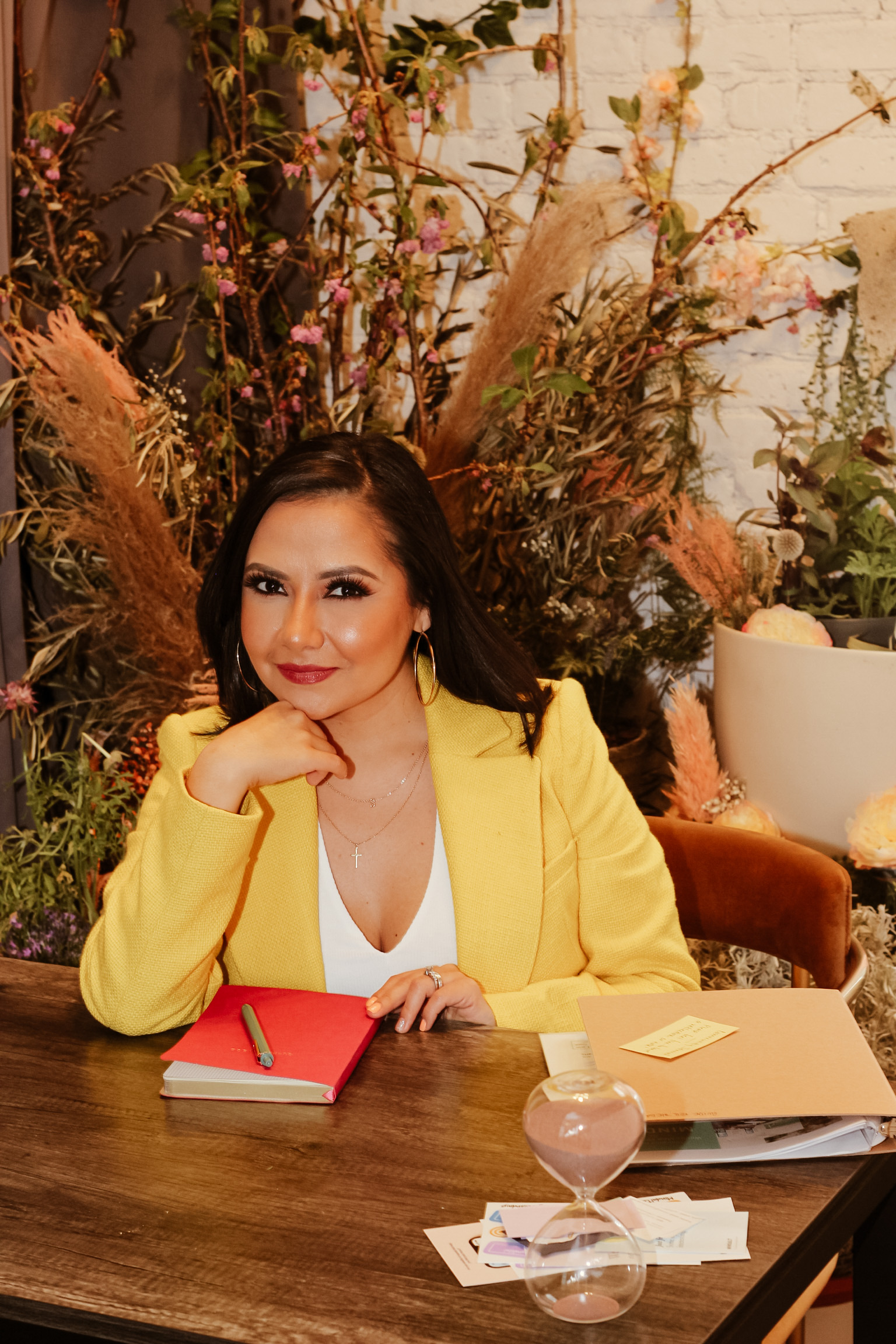 Alexandra Diaz-Izurieta seated at her desk in a yellow blazer